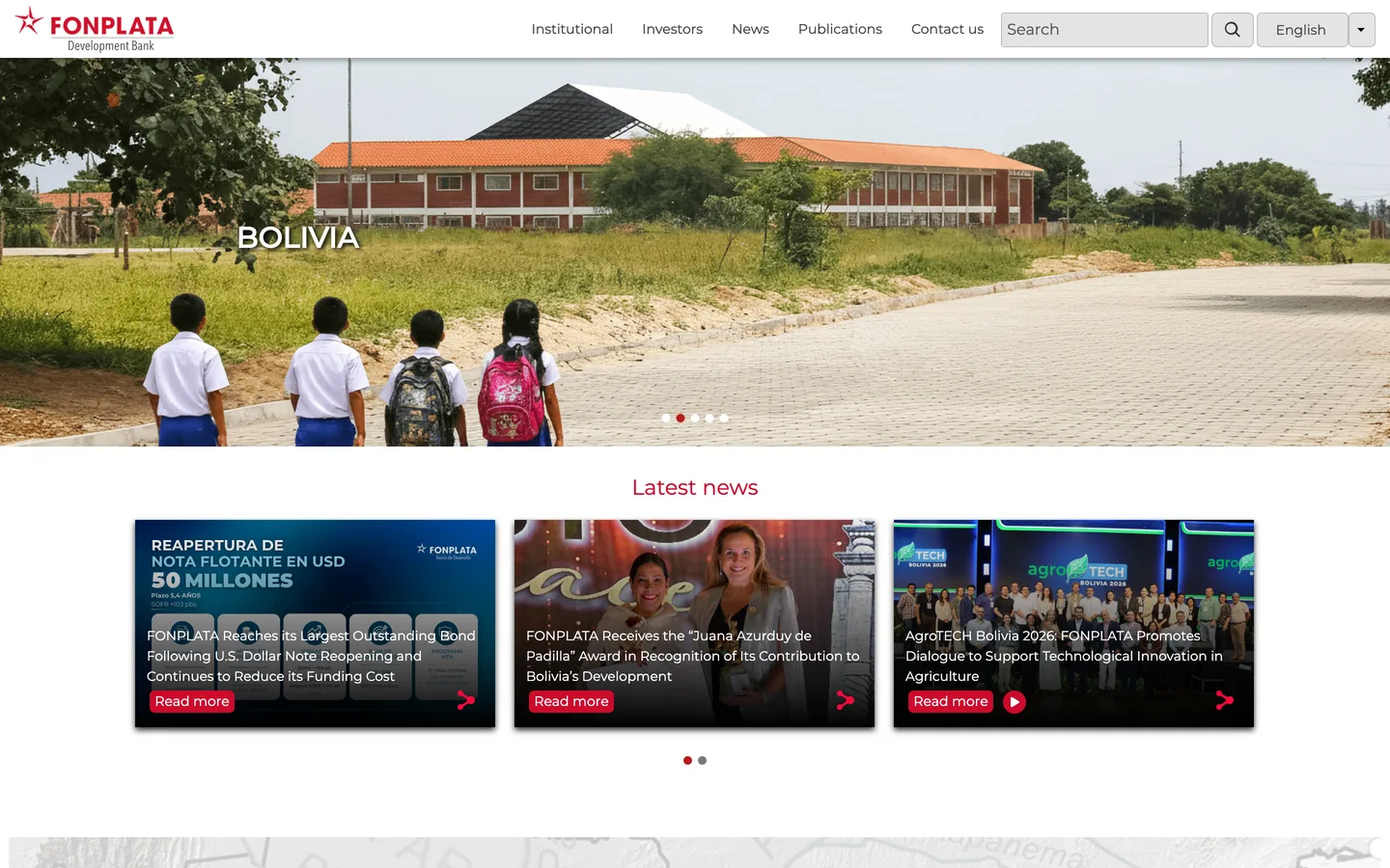 FONPLATA English homepage with a Bolivia school-road hero slide and three Latest news cards
